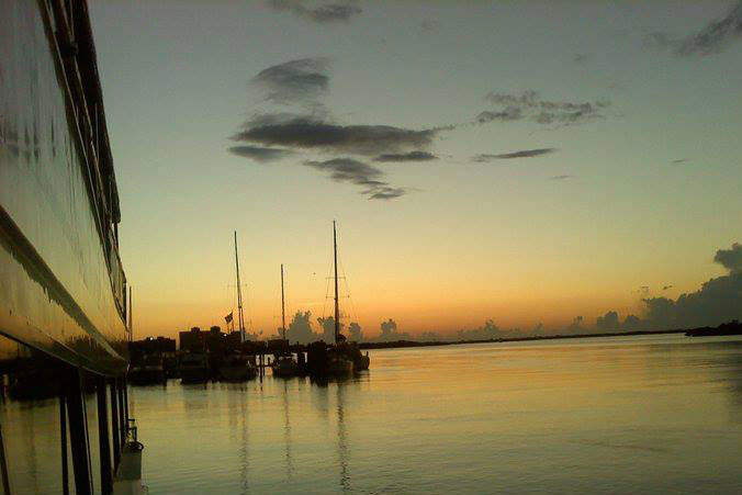 image of sunset over back bay, sailboats